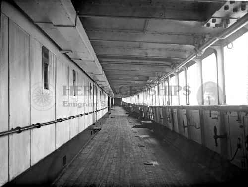 A picture of the sheltered promenade deck on the Cunard Line steamships Lucania or Campania. The two ships were identical sisters, and it has not been possible to determine on which of the two this photograph was taken, but it is most likely from the Lucania.