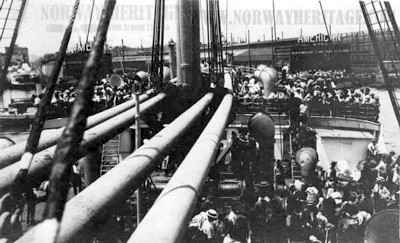 Deck life – Steerage passengers on deck of the Hamburg America Line…