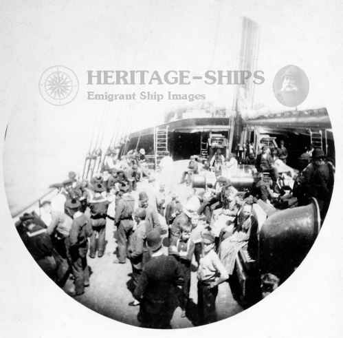 This old photograph was taken with a Kodak No. 1 camera, introduced in 1888. It was taken by an amateur and shows steerage passengers busy on the deck of a steamer sailing with emigrants from Europe to America. 